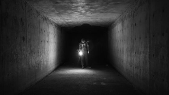 Flashlight in an underground concrete bunker.